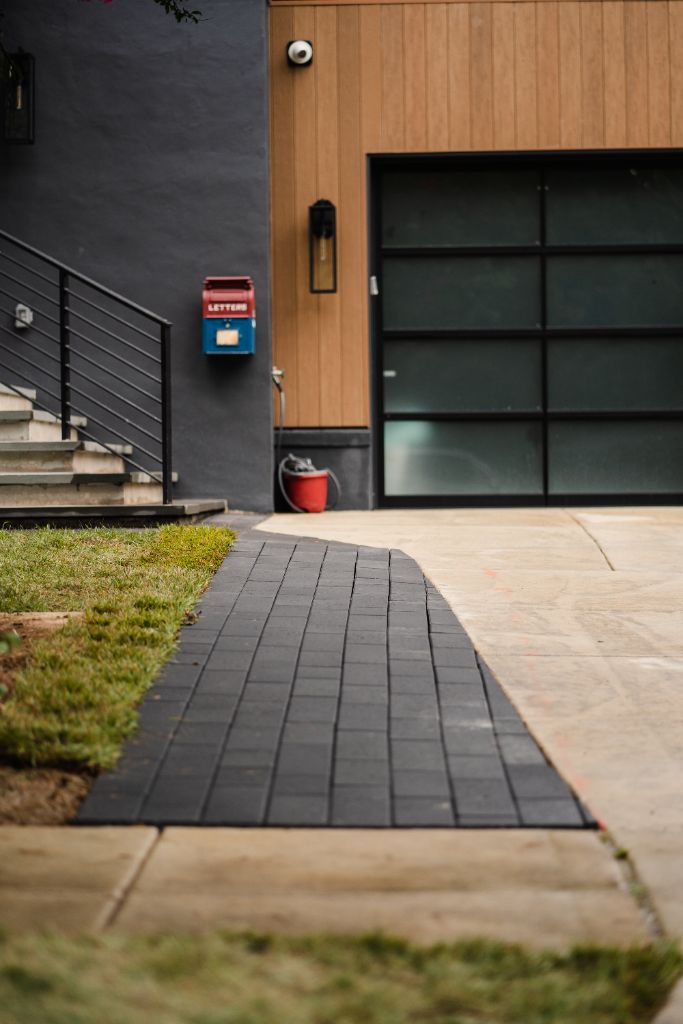 Modern black paver walkway to garage