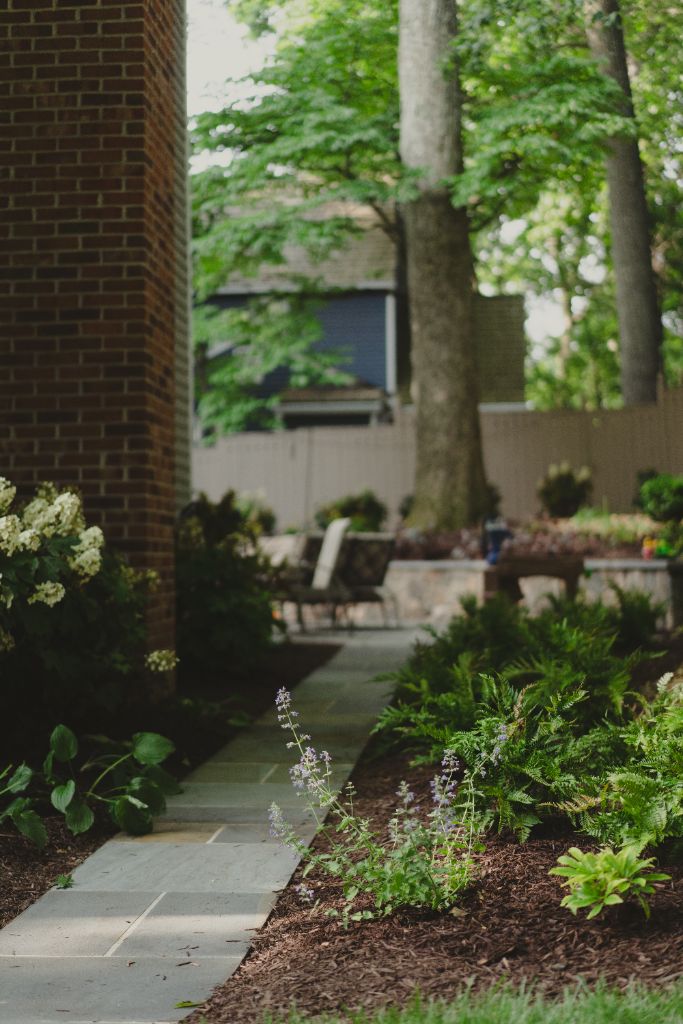 Brick walkway leading to garden courtyard