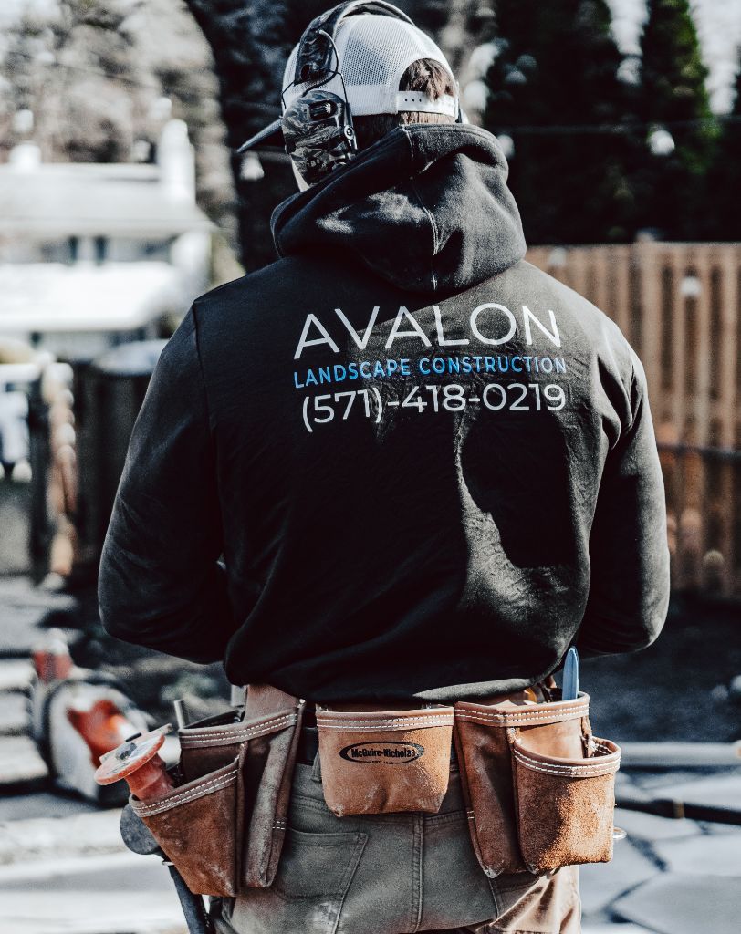 Avalon crew member with tool belt on hardscape jobsite