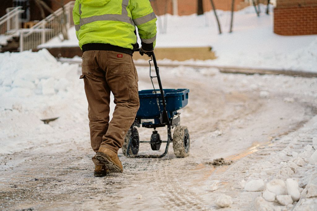 Avalon crew salting sidewalks and steps in hi-vis gear